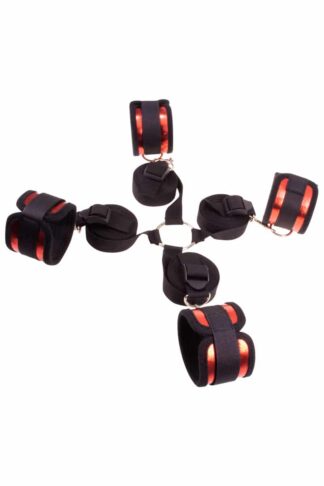 Kit d'attaches de lit Piège du Désert bicolore rouge et noir avec quatre sangles ajustables reliées à un anneau central.